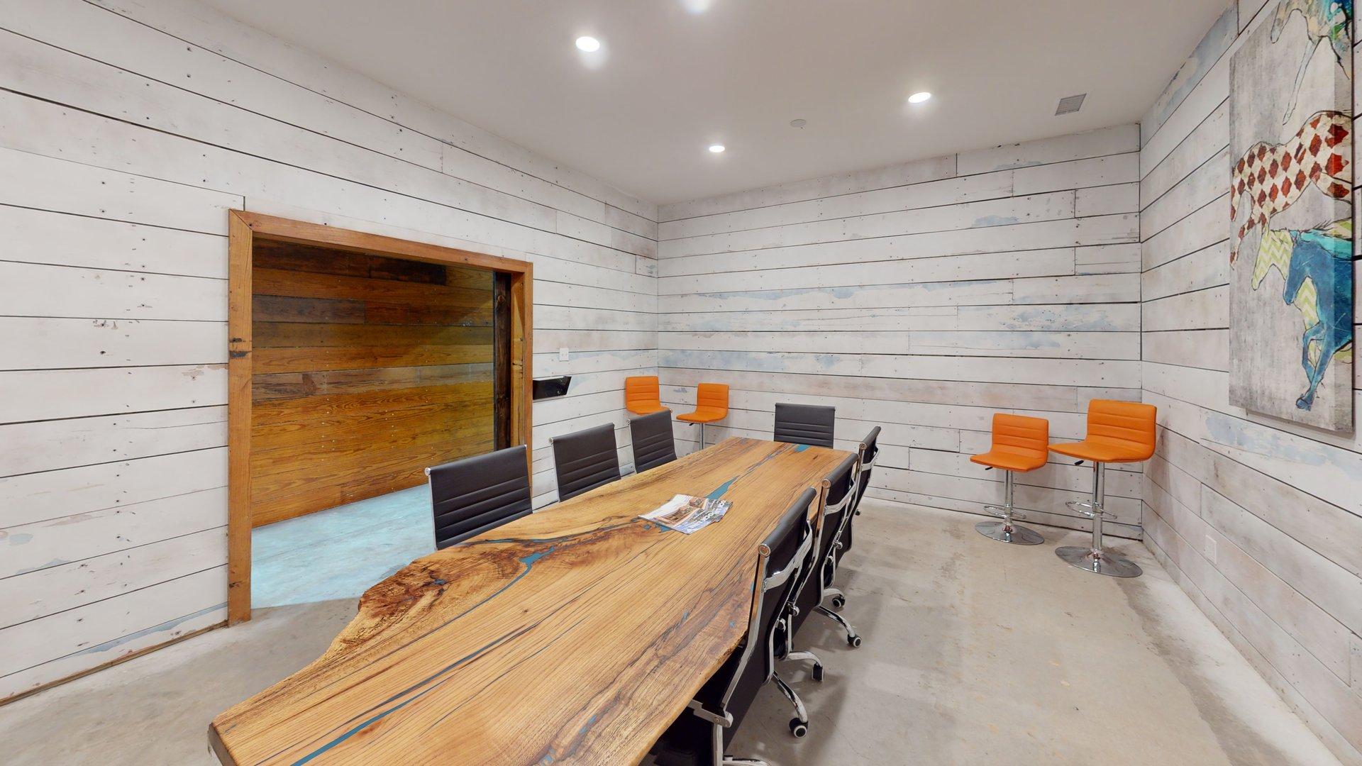Conference room with wood table and mounted display