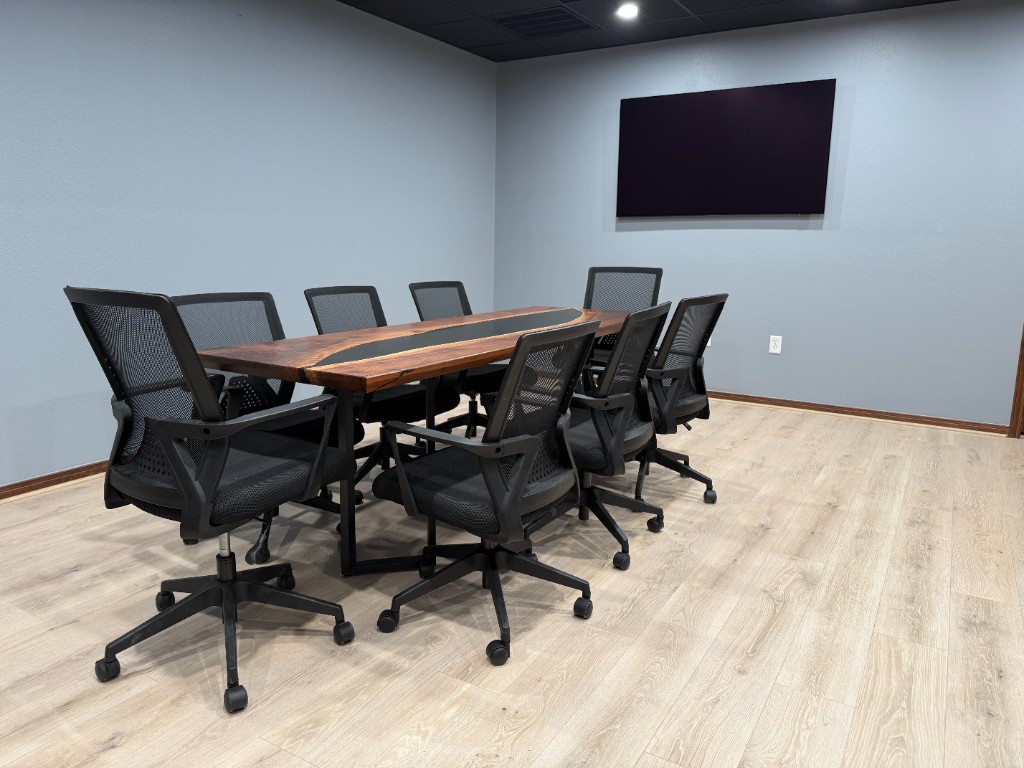 Sycamore Conference Room with epoxy table and mounted display
